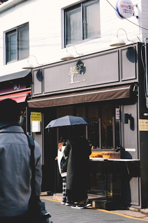A modern storefront with a stylish canopy providing shade.
