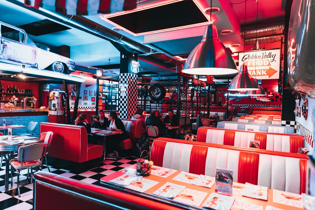 a restaurant with red and white checkered tables and booths,