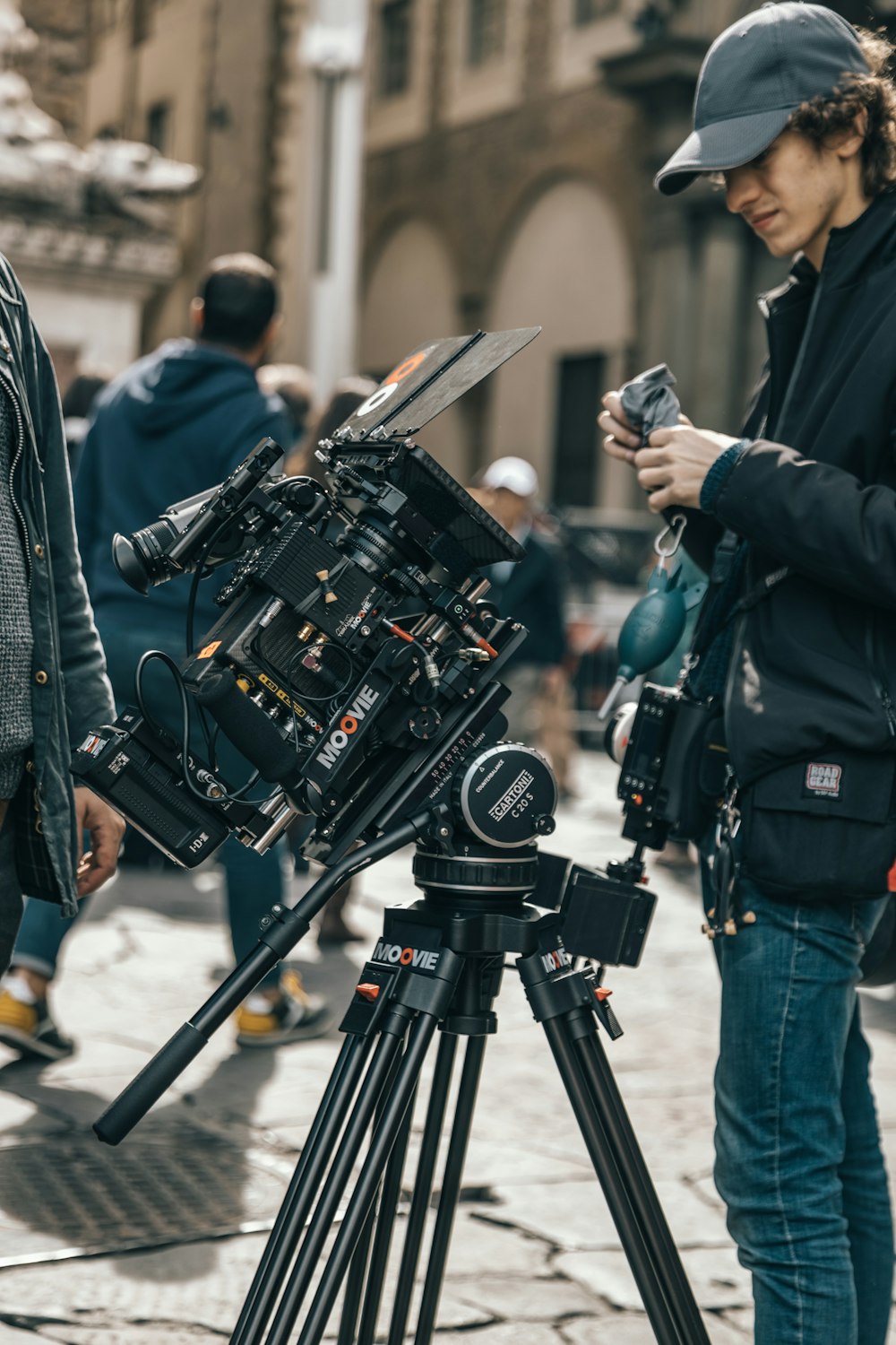 man standing beside professional camera