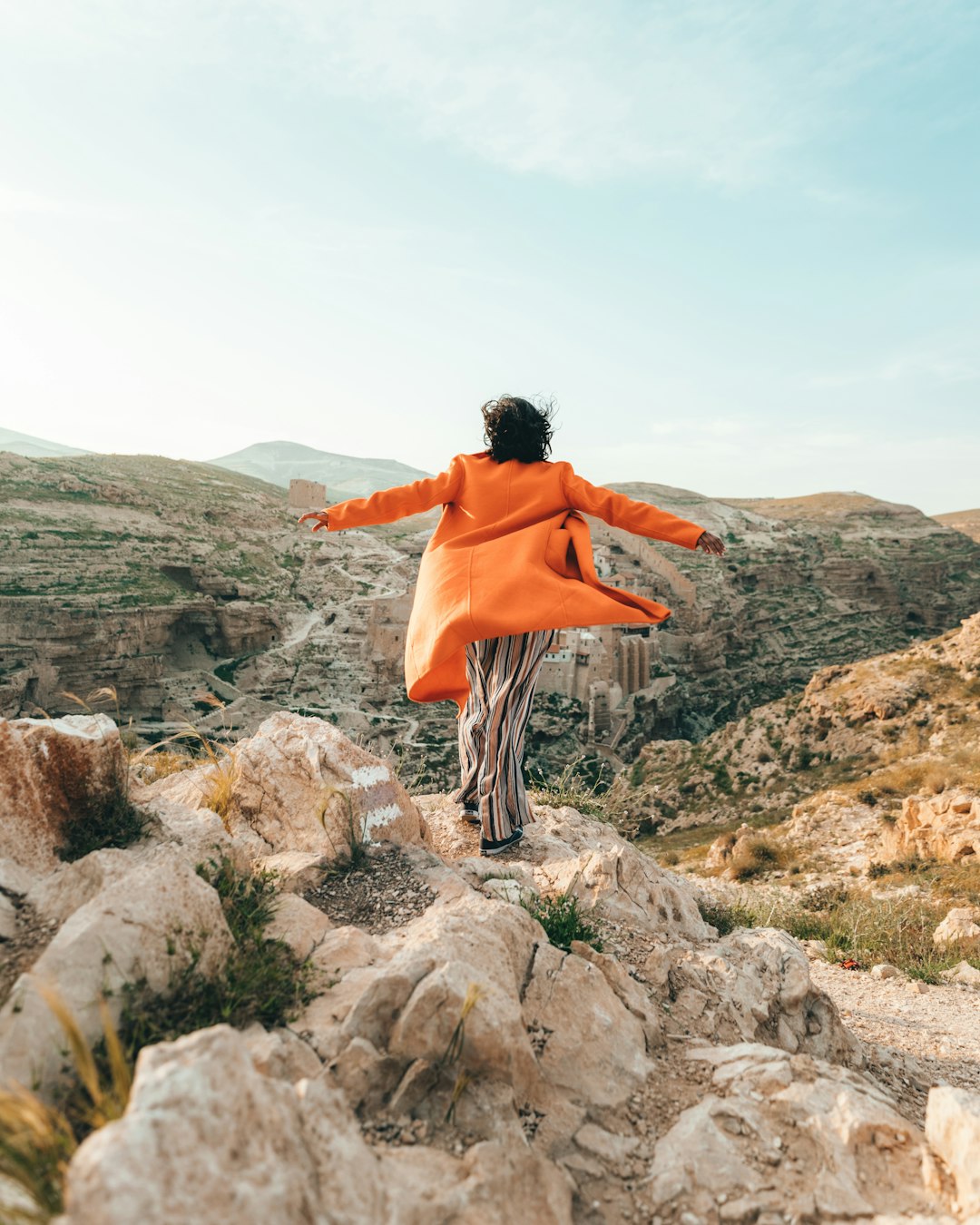 person standing on cliff during daytime