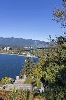 A scenic view of Puget Sound with engineers inspecting a bridge construction site.