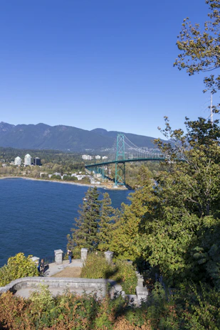 A scenic view of Puget Sound with engineers inspecting a bridge construction site.