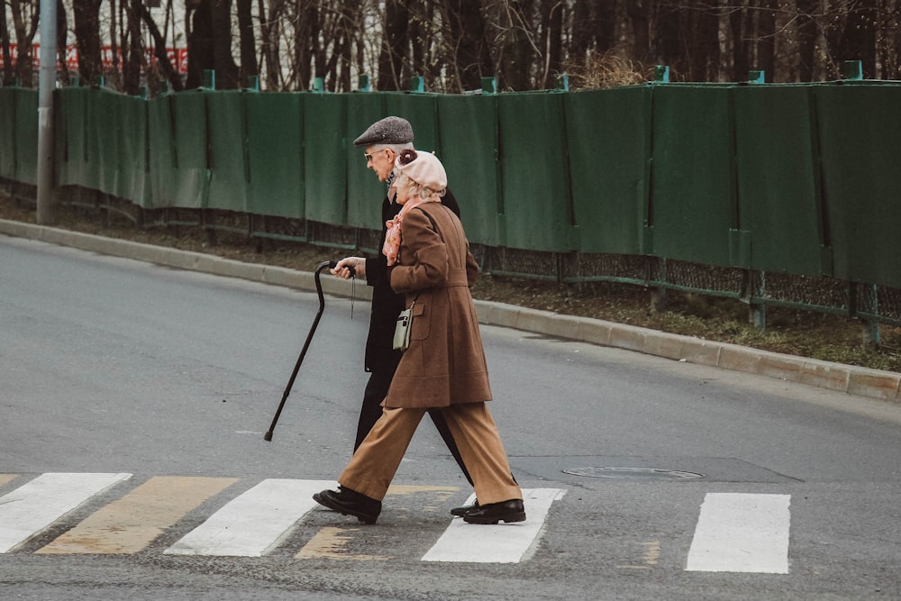 man and woman walking on pedestrian line during daytime