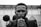 grayscale photography of man sipping on straw