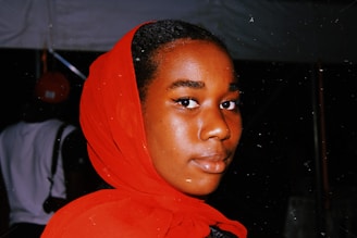 A vibrant close-up of a famous Arab celebrity smiling at a red carpet event.