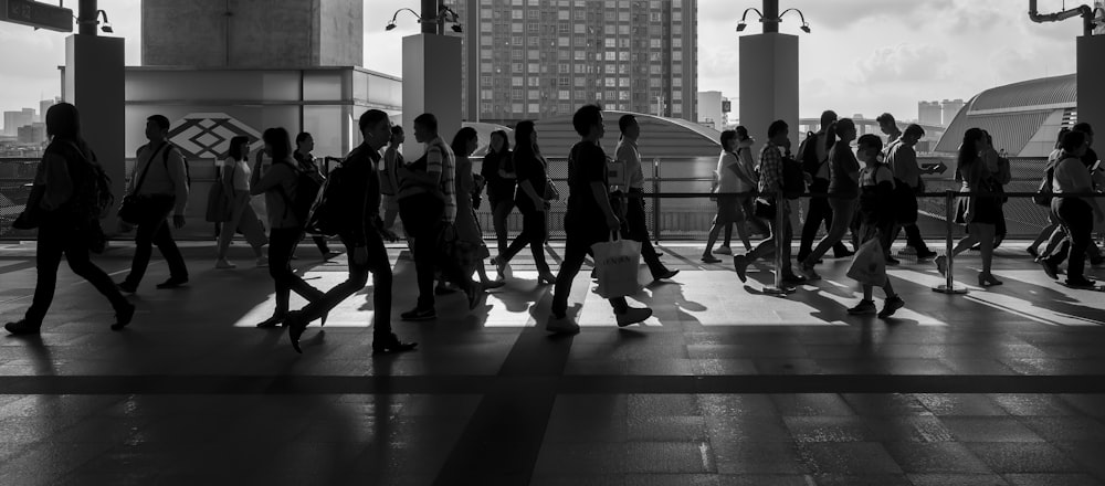 바닥에 걷는 사람들의 회색조 사진