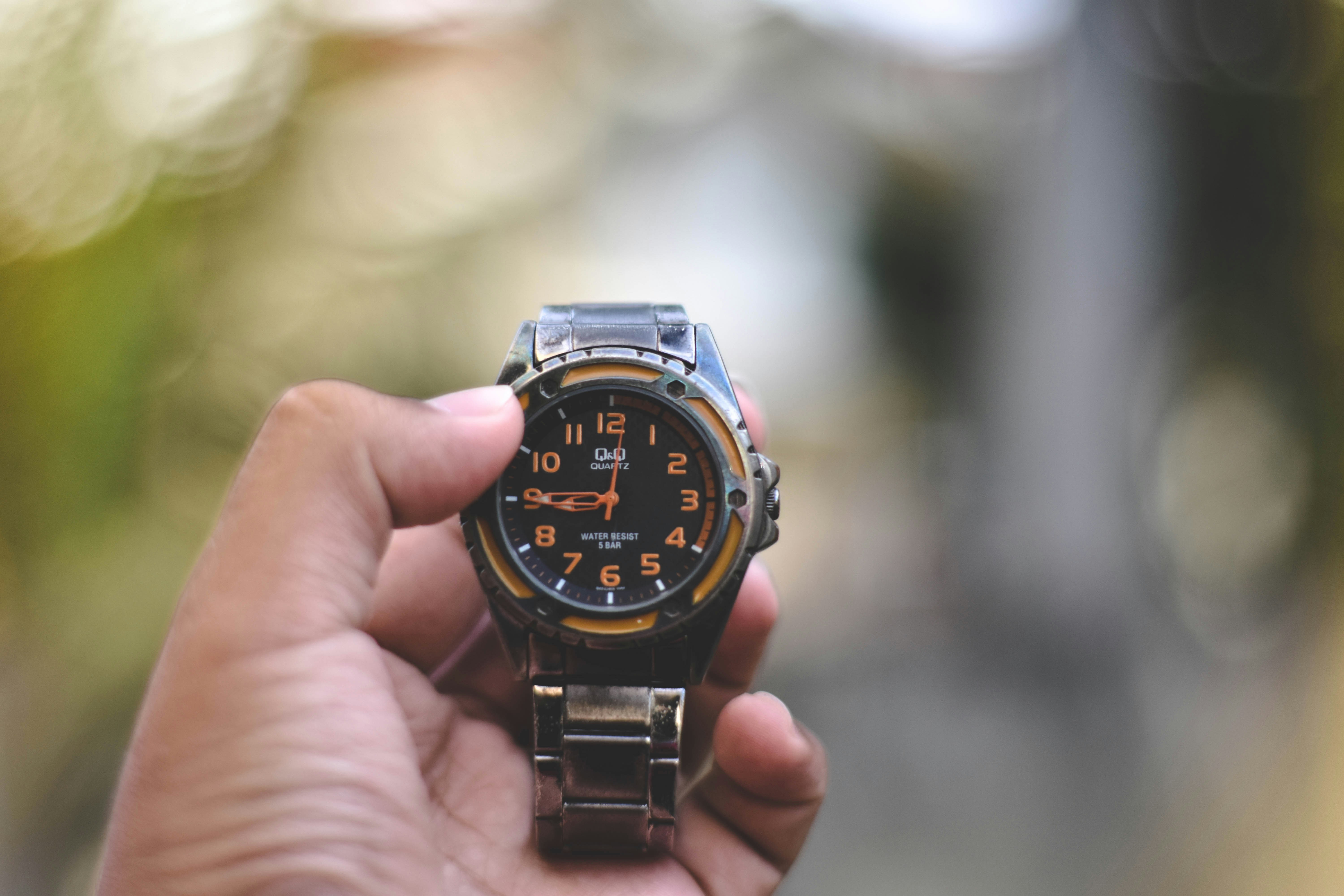 round black analog watch with link bracelet