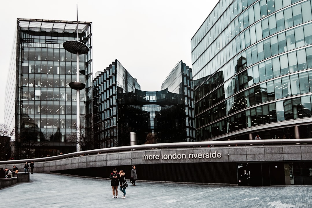 a group of people walking in front of a building,