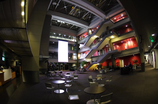 Interior view of a bright, tech-enabled office lobby bustling with professionals.