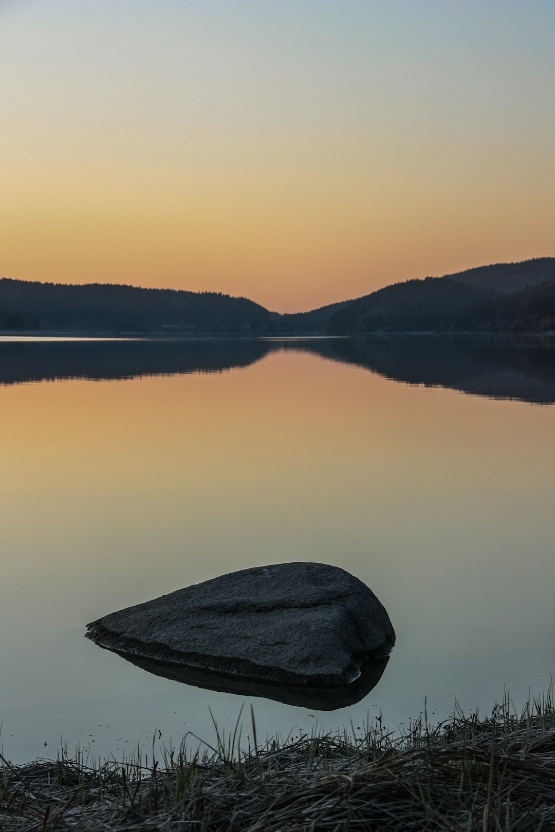 body of water under grey sky