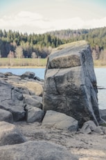 a large rock sitting on top of a sandy beach