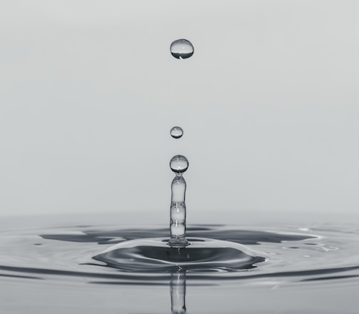 a drop of water falling into a body of water