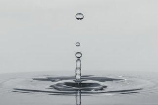 a drop of water falling into a body of water