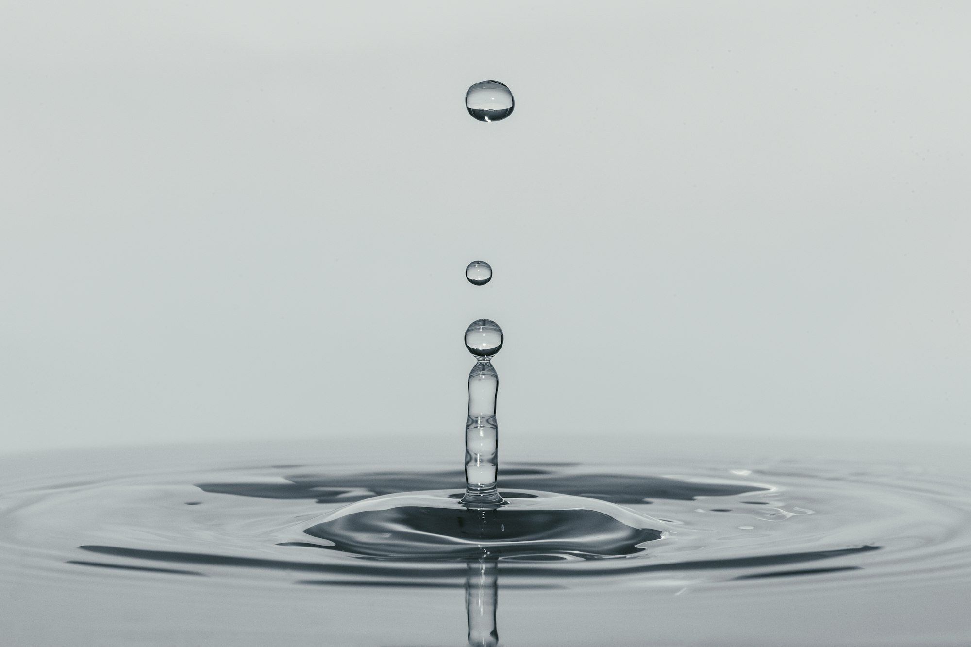 a shot of water dripping, with water drops hovering over a pool of water below. Really cool!