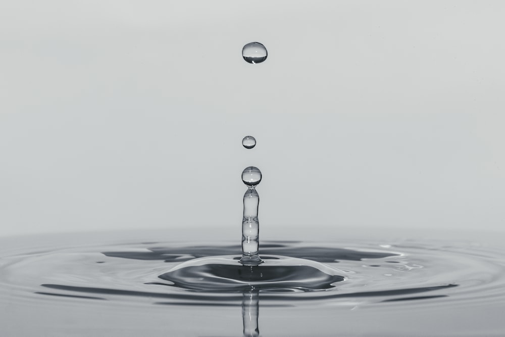 a drop of water falling into a body of water