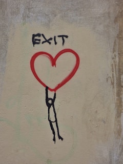 a drawing of a person holding a heart on a wall