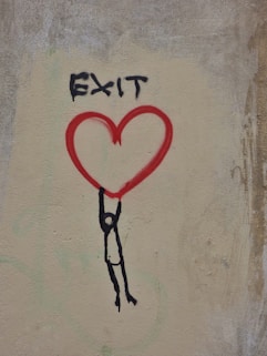 a drawing of a person holding a heart on a wall