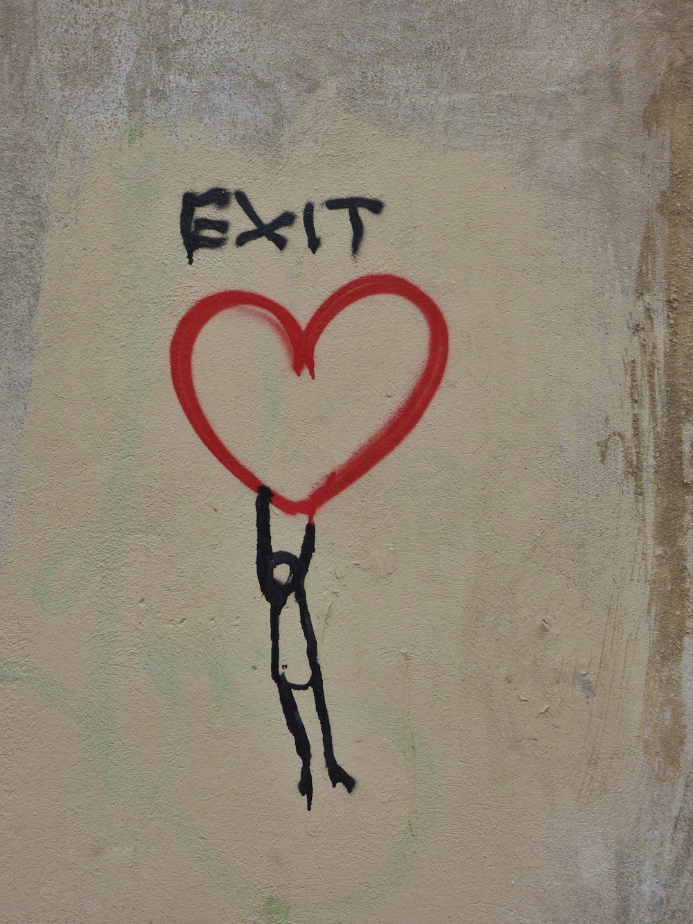 a drawing of a person holding a heart on a wall