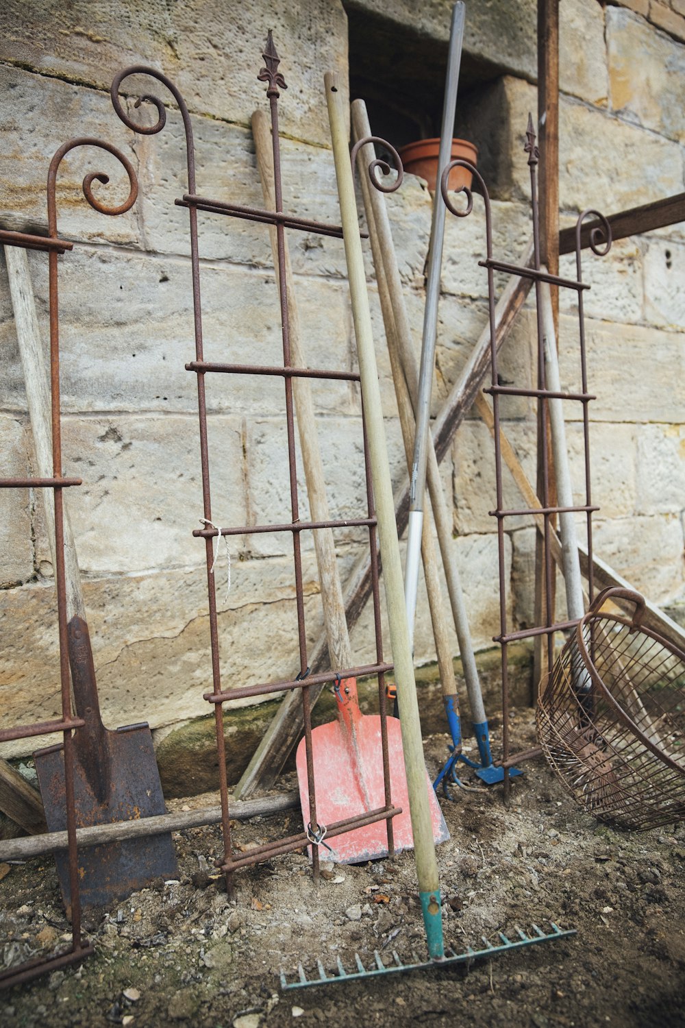 several gardening tools leaning on wall