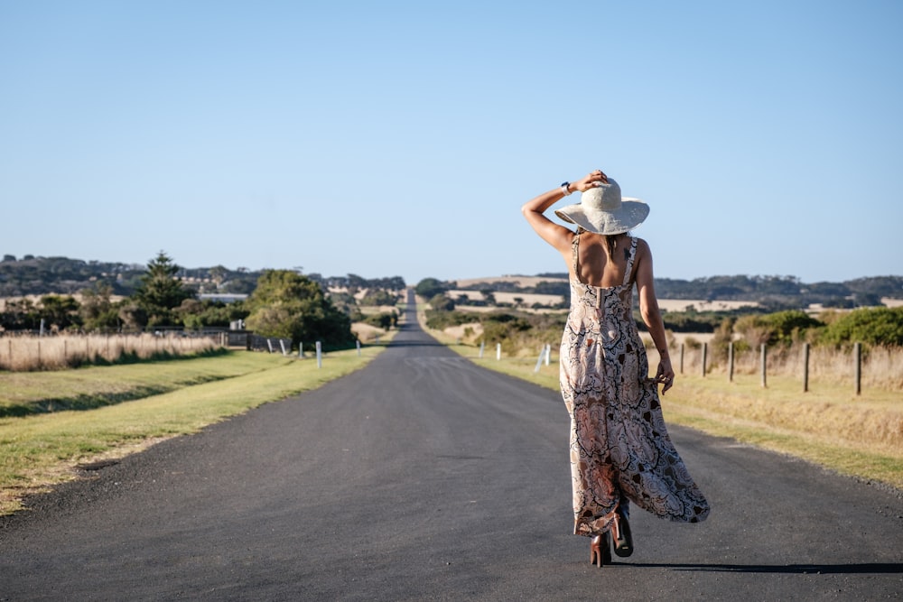 woman walking on concrete road