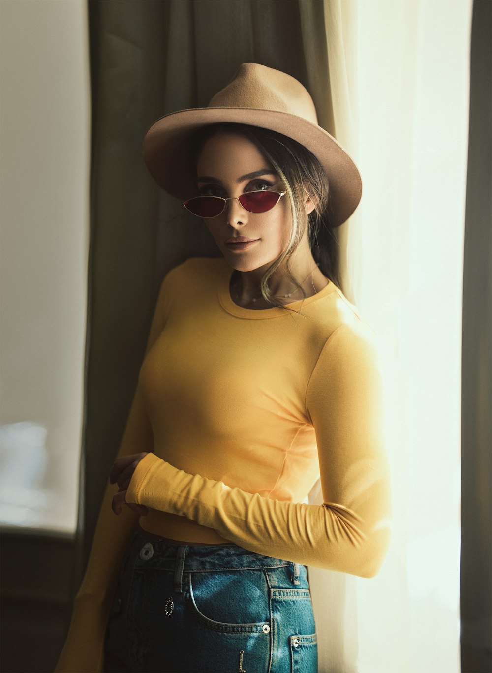 woman wearing yellow long-sleeved top inside room