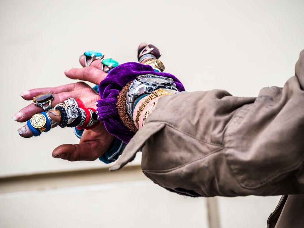 person with assorted rings in hands