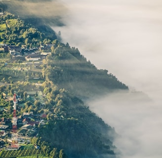 aerial photo of village beside mountain