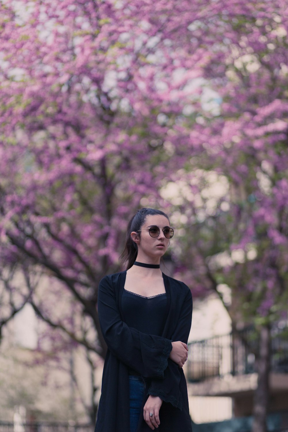 low angle photo of woman standing near trees