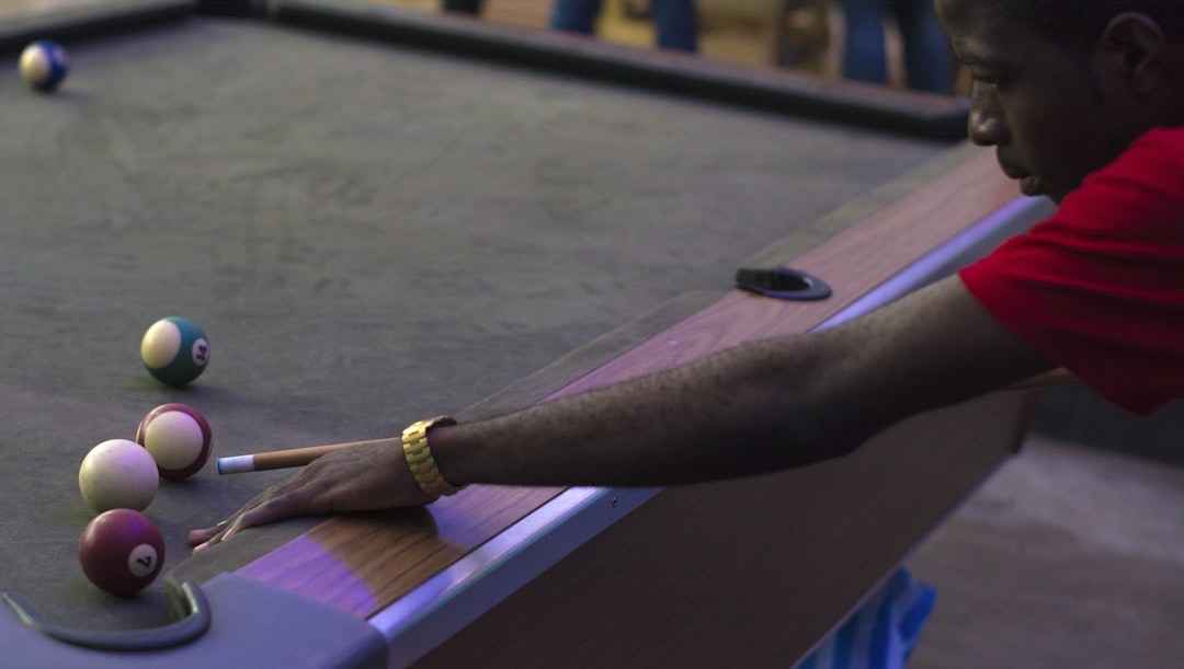 man playing billiard,