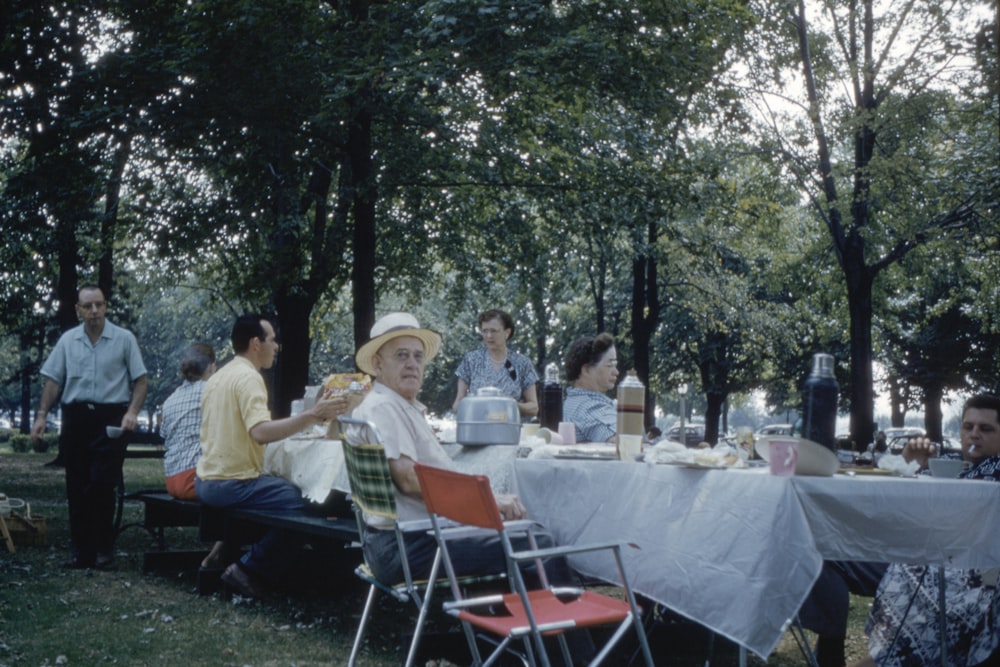 people sitting on chair beside table