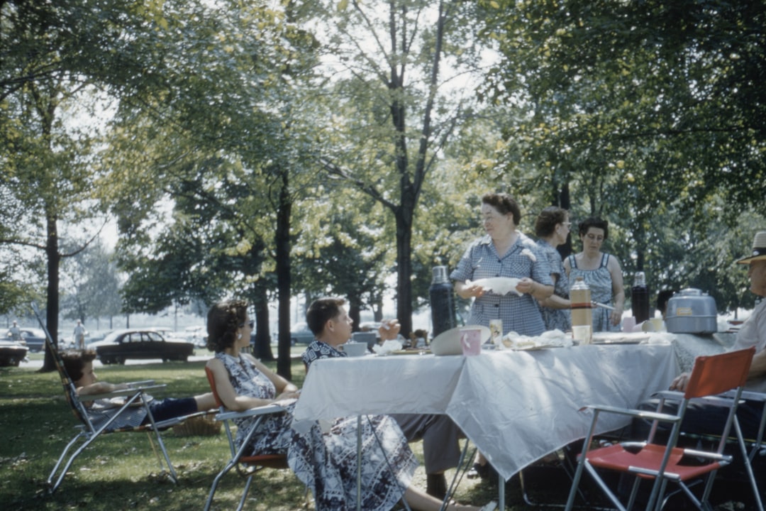 woman in blue dress standing near table