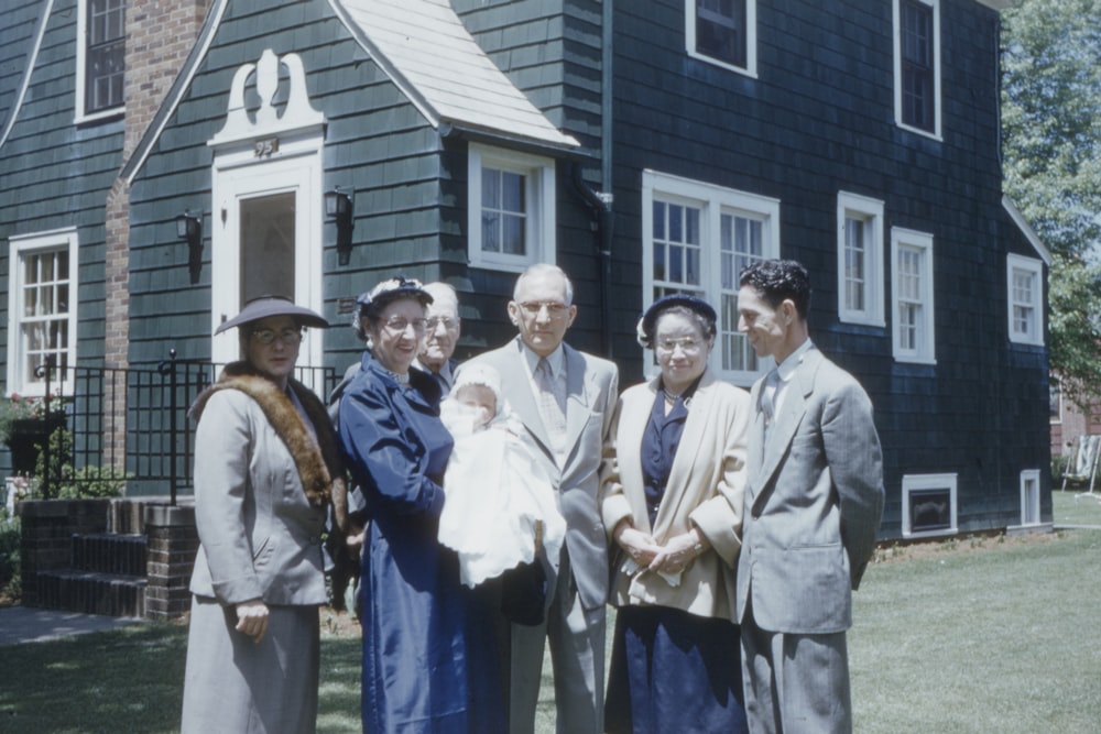 group of people standing near house