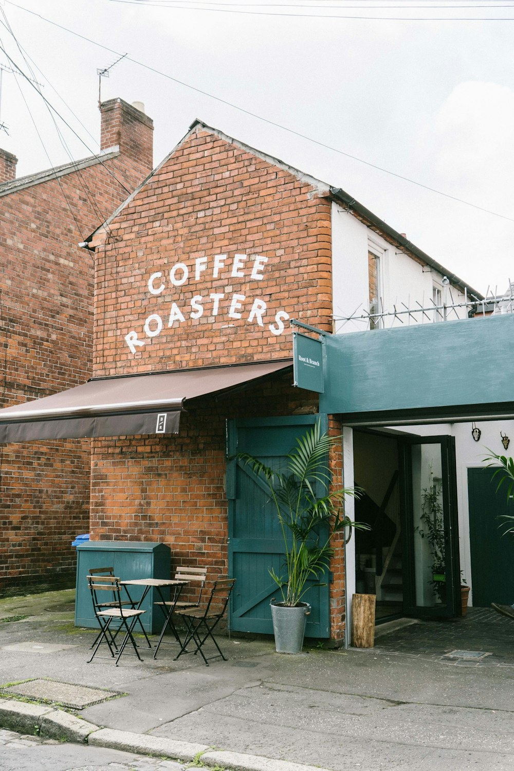 a brick building with a sign that says coffee roastery