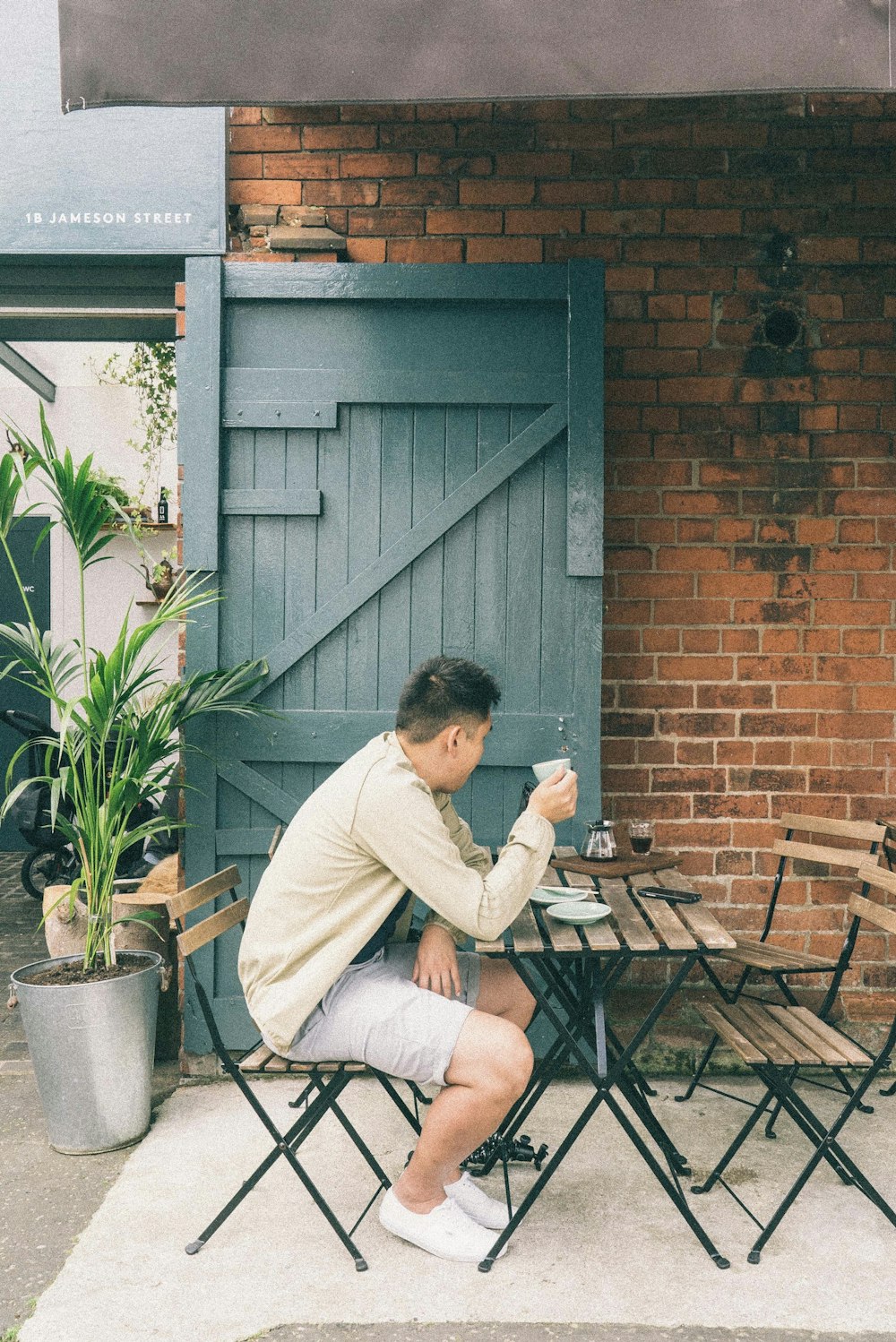 man sitting on chair holding mug