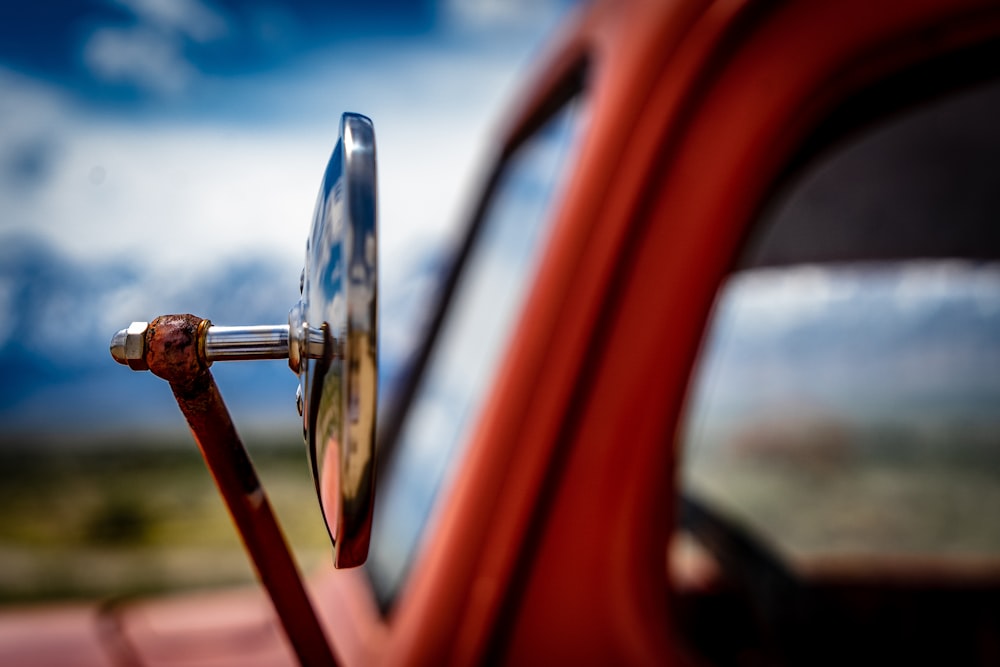 selective focus photography of silver wing mirror
