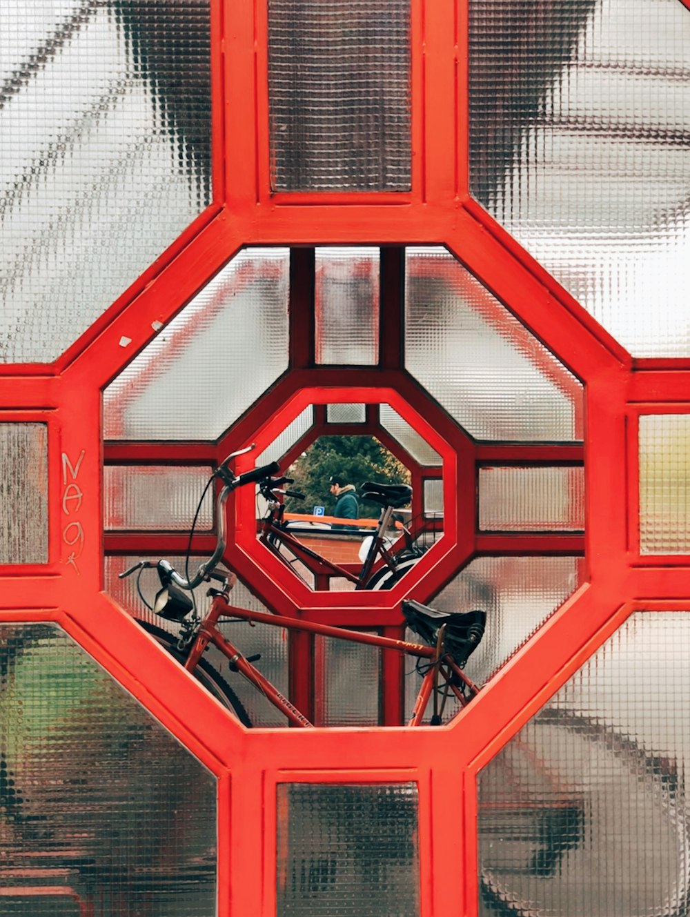 a bicycle parked inside of a red structure