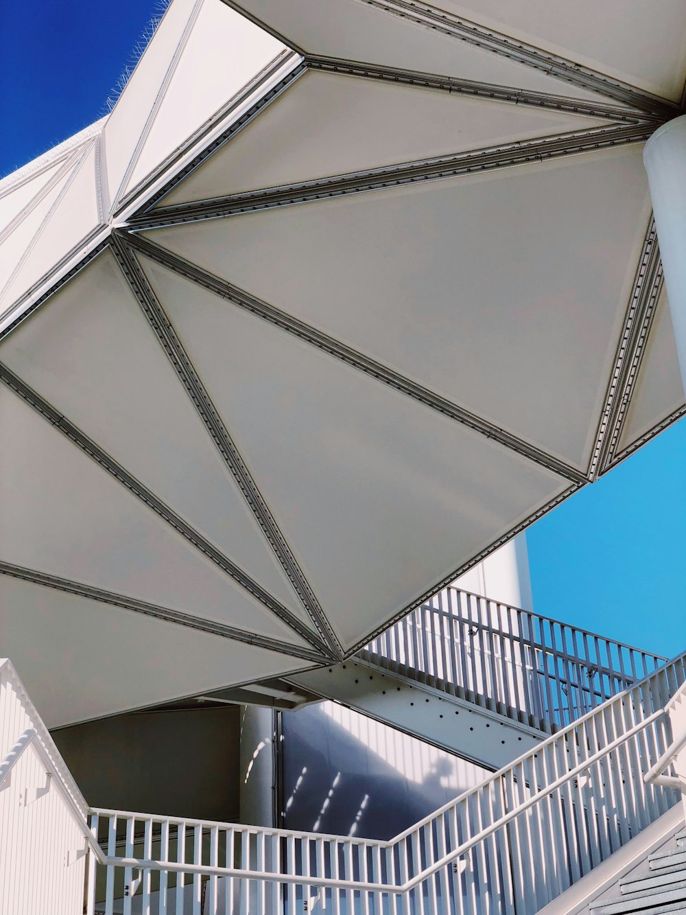 a large white umbrella sitting on top of a building