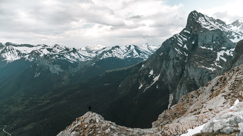 man standing on top of mountain