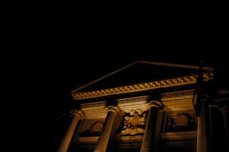 Night view of a building exterior highlighting illuminated decorative elements.