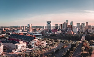 American football arena beside building and roadway during daytime