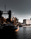 Bulk vessel loaded with silica sand docked at a Western Australian port under clear skies.