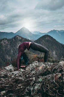 woman back flipping on rocks