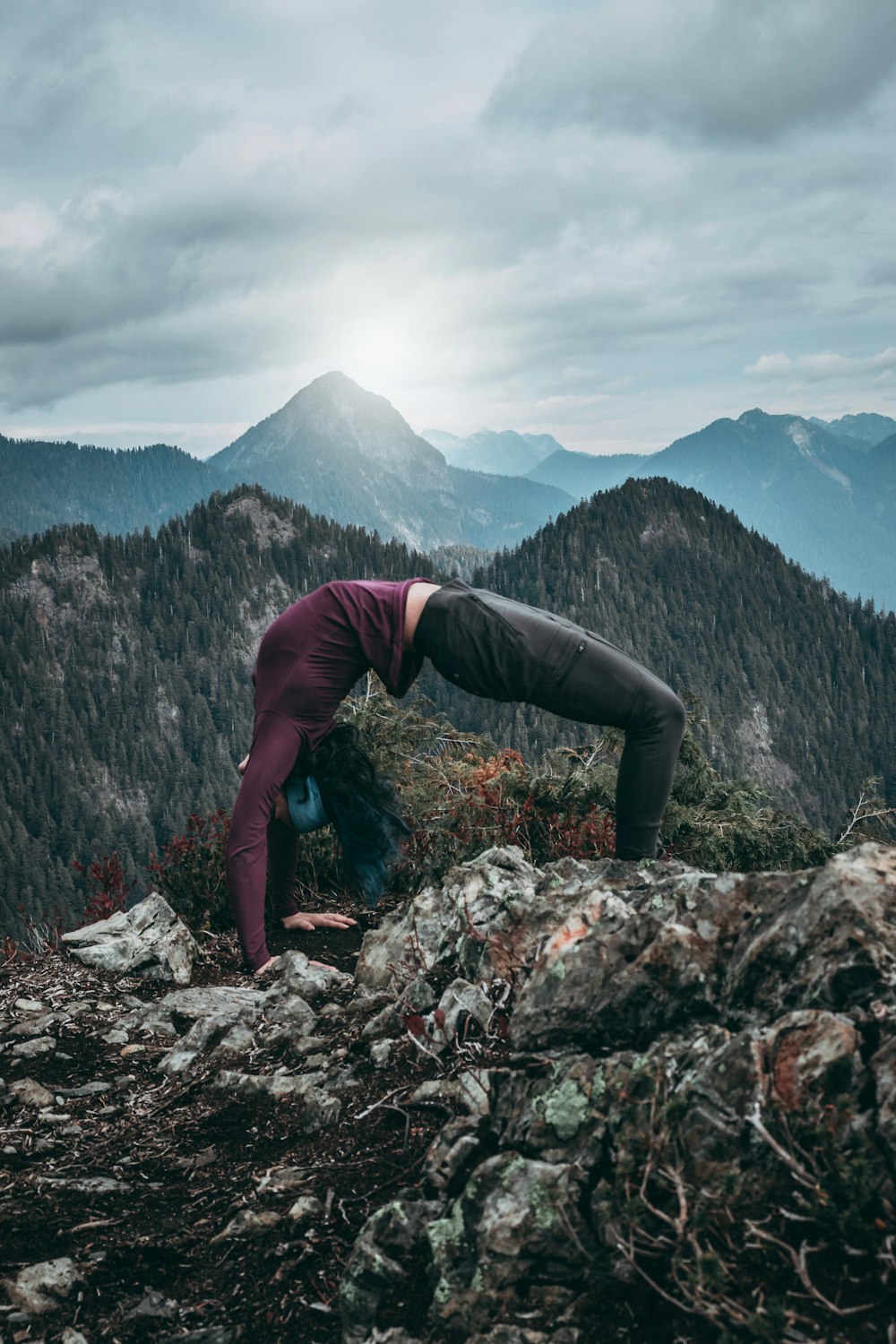 woman back flipping on rocks