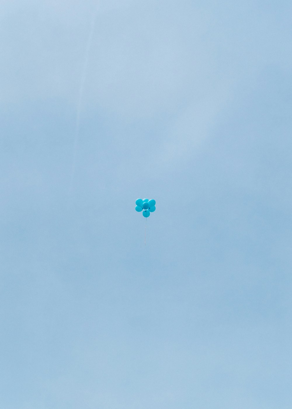 a couple of kites flying through a blue sky