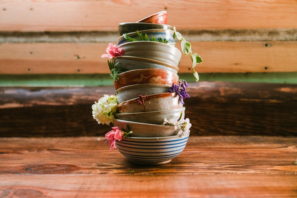 brown and blue ceramic bowls on beige plank