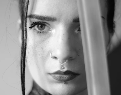 Close-up of an actress with dramatic makeup and intense gaze.