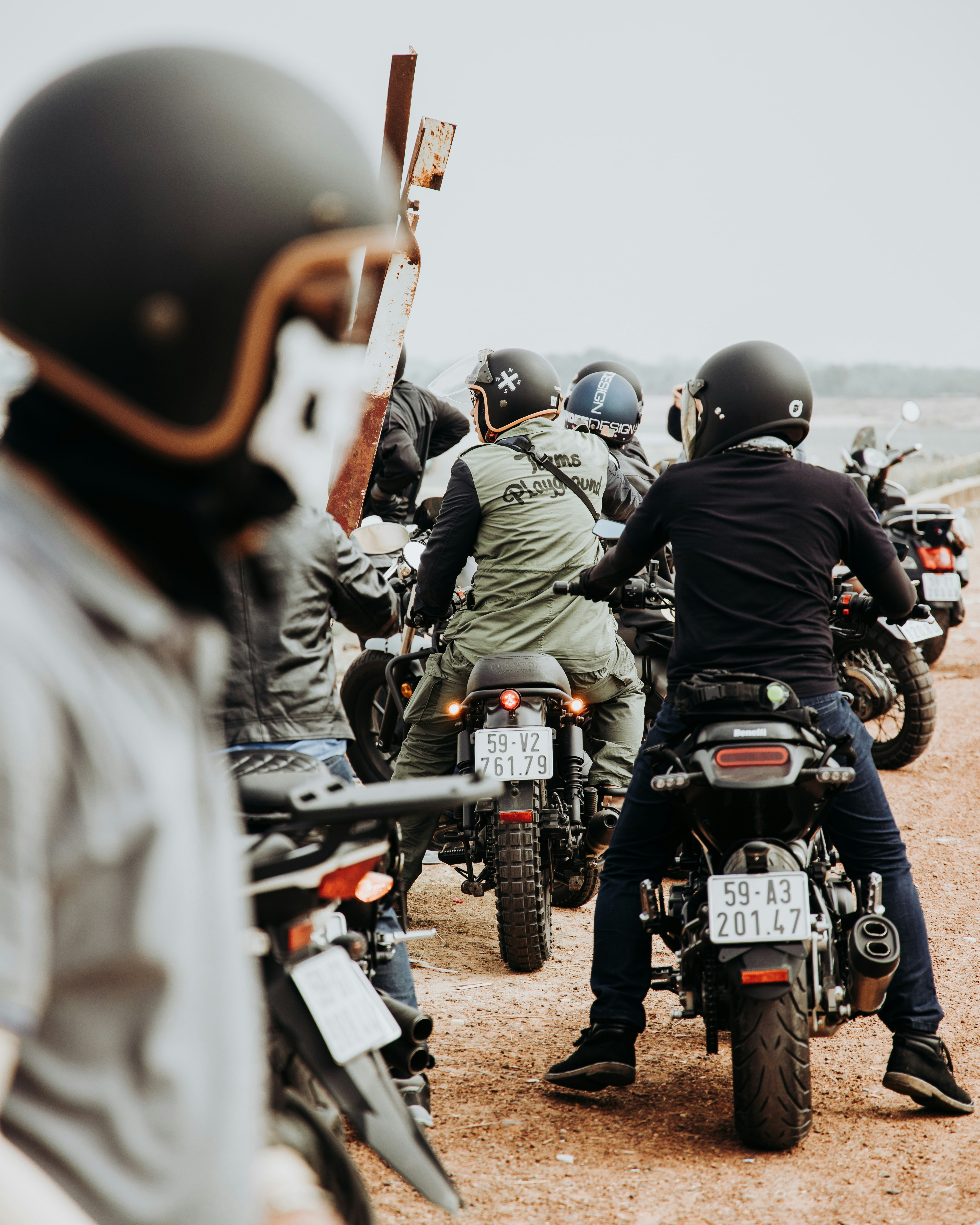 man wearing black long-sleeved shirt sitting on motorcycle