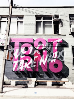 a large pink and black mural on the side of a building
