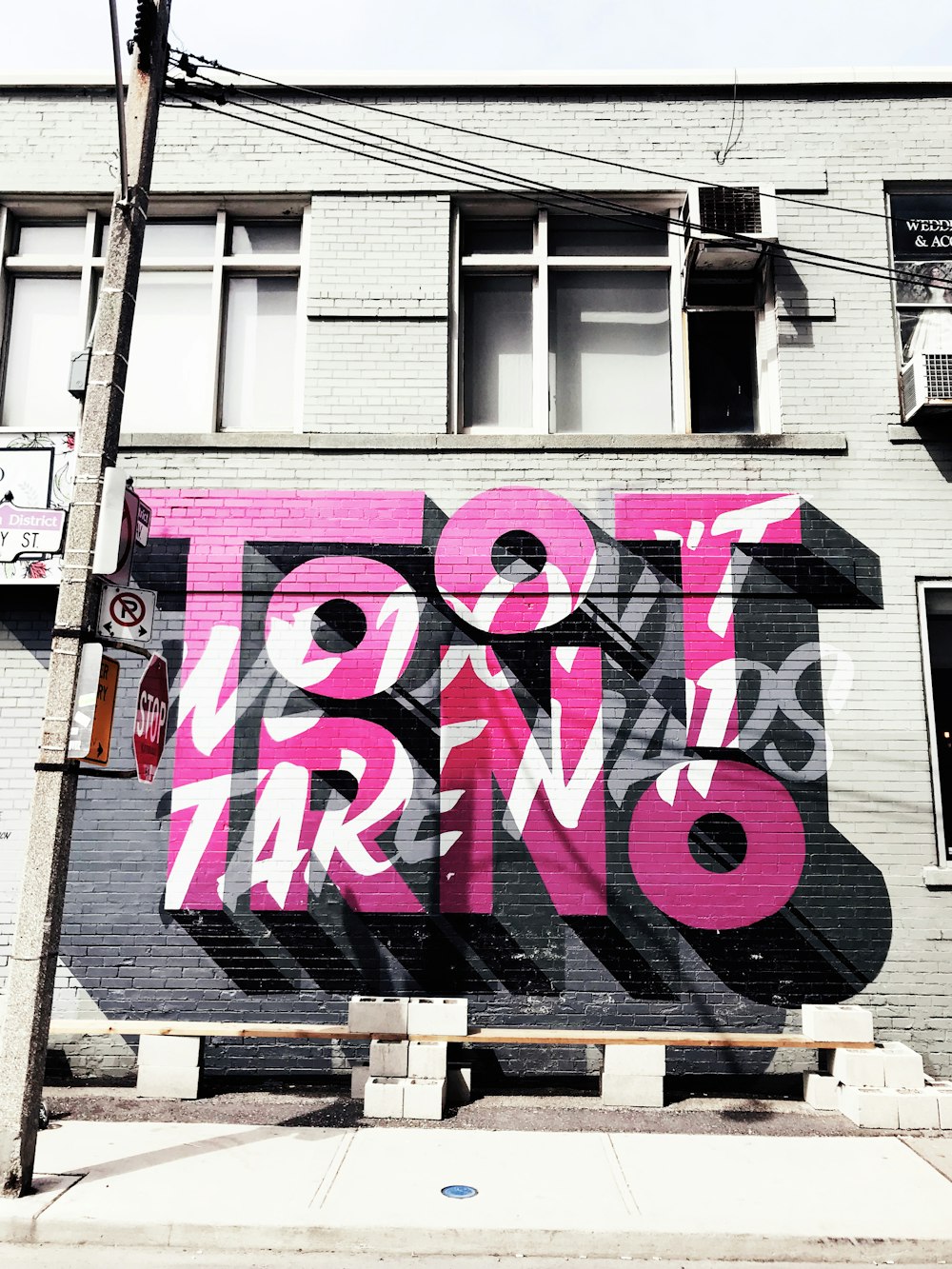 a large pink and black mural on the side of a building