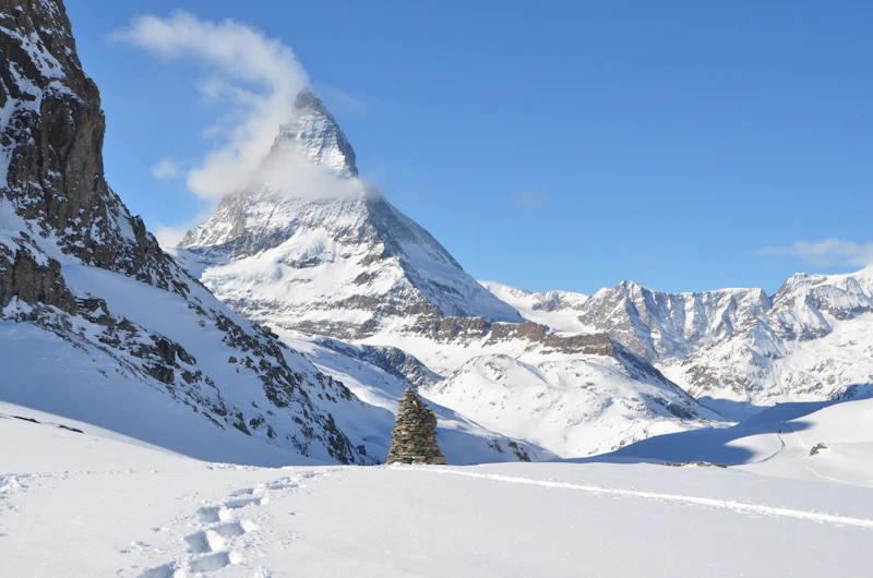 The snow-covered Matterhorn under a clear sky above Zermatt in winter